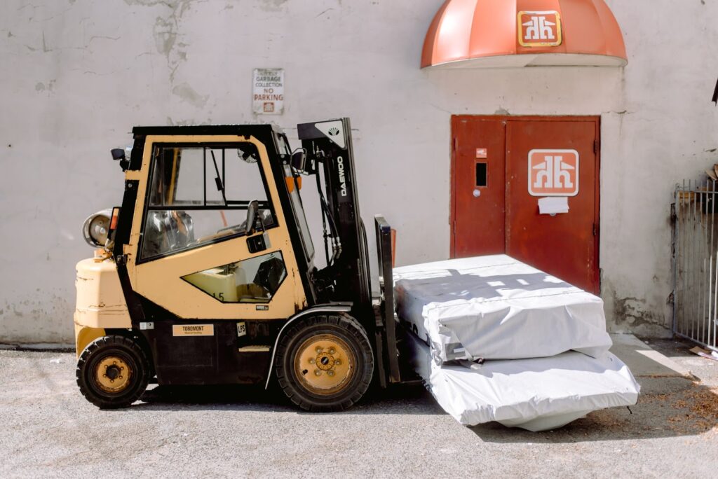 A forklift lifting two items.