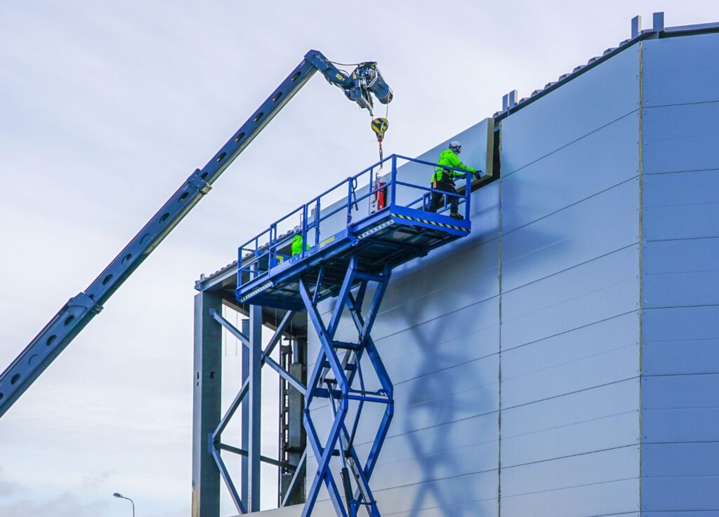 A man doing repair work using scissor lift